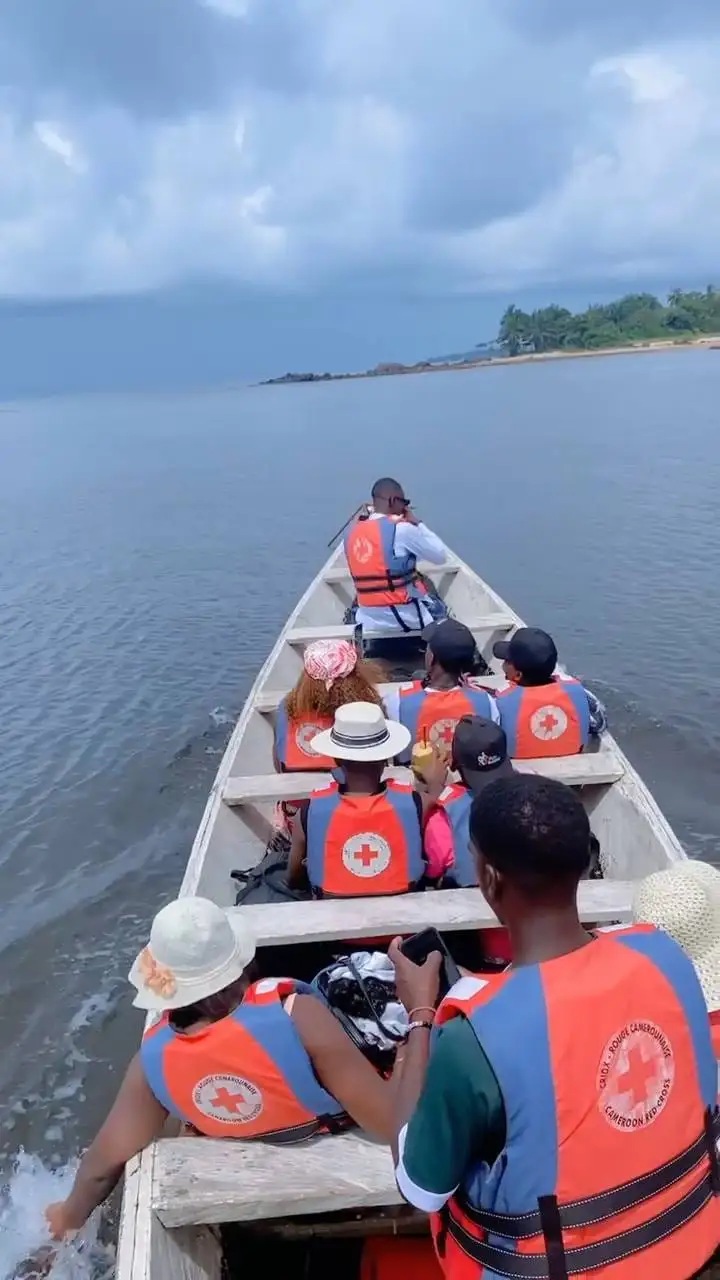 Une chaloupe chargée de passagers en gilet de sauvetage, sur l’eau