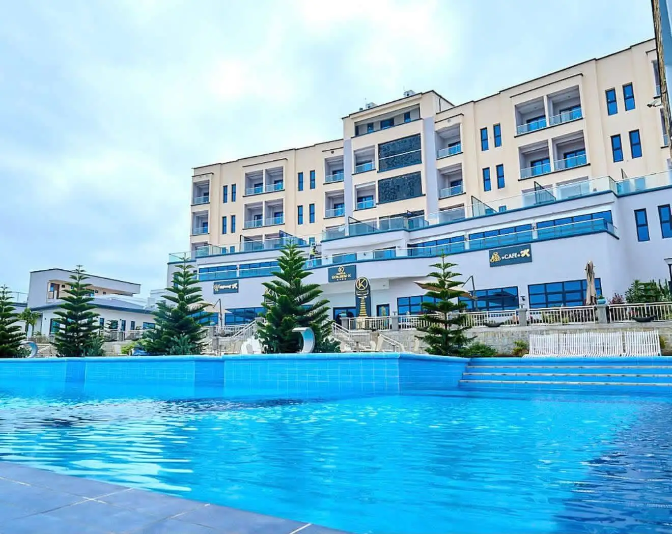 The Golden K hotel pool, with the façade and its balconies behind