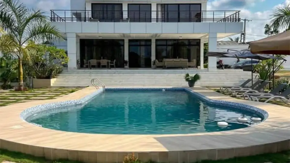 Une villa avec piscine, entourée de verdure
